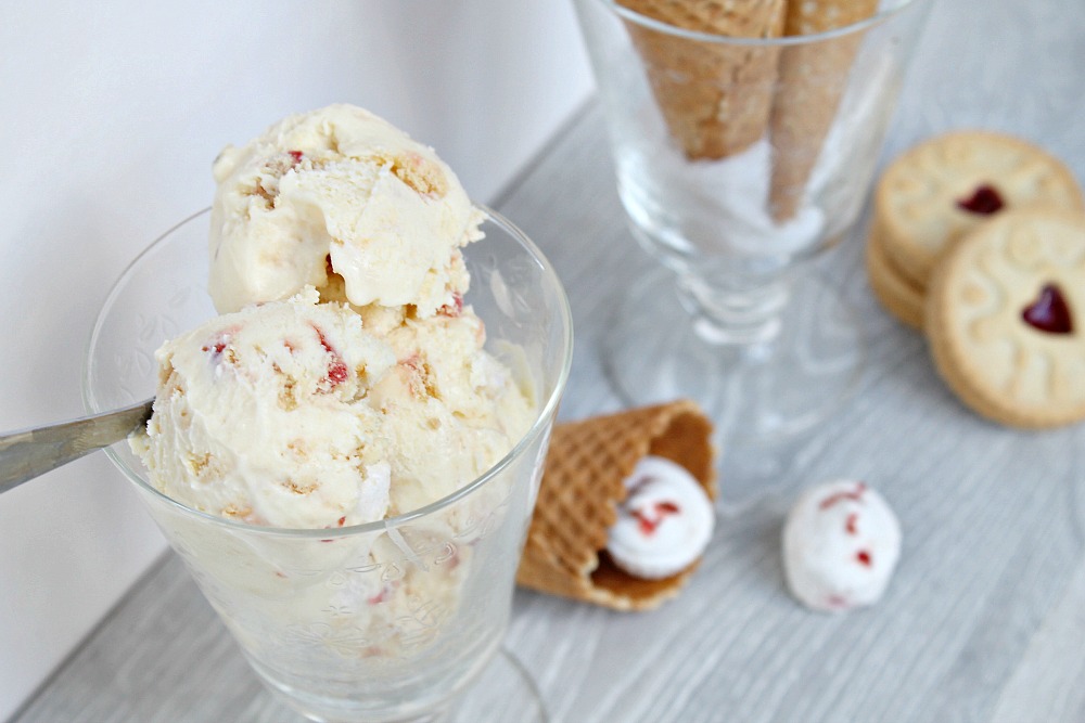 A glass containing scoops of jammy dodger marshmallow ice cream