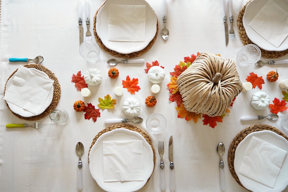 A Thanksgiving tablescape with pumpkins and leaves