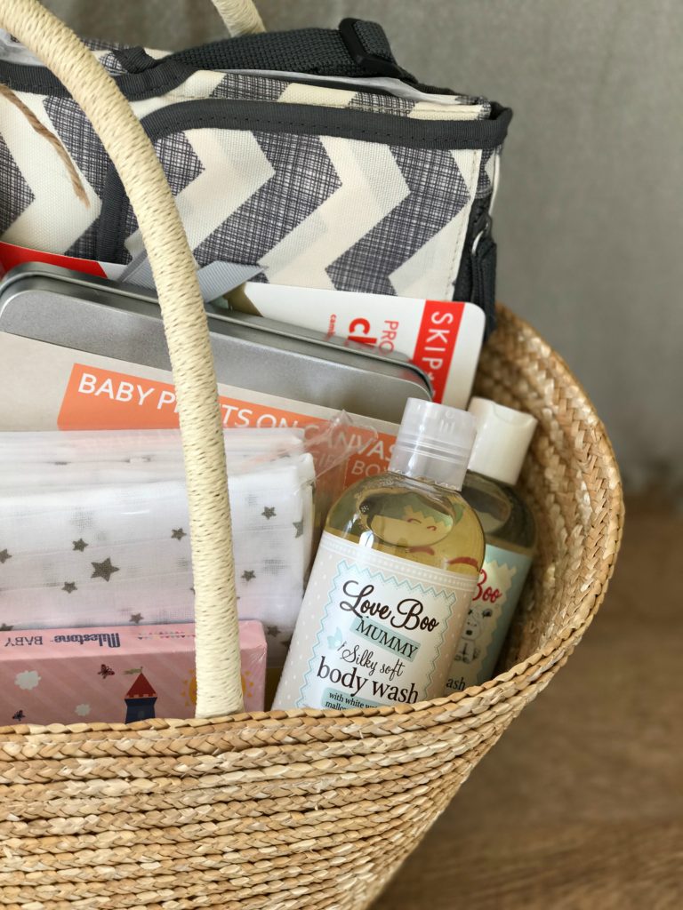 A basket with items for a new mum in them