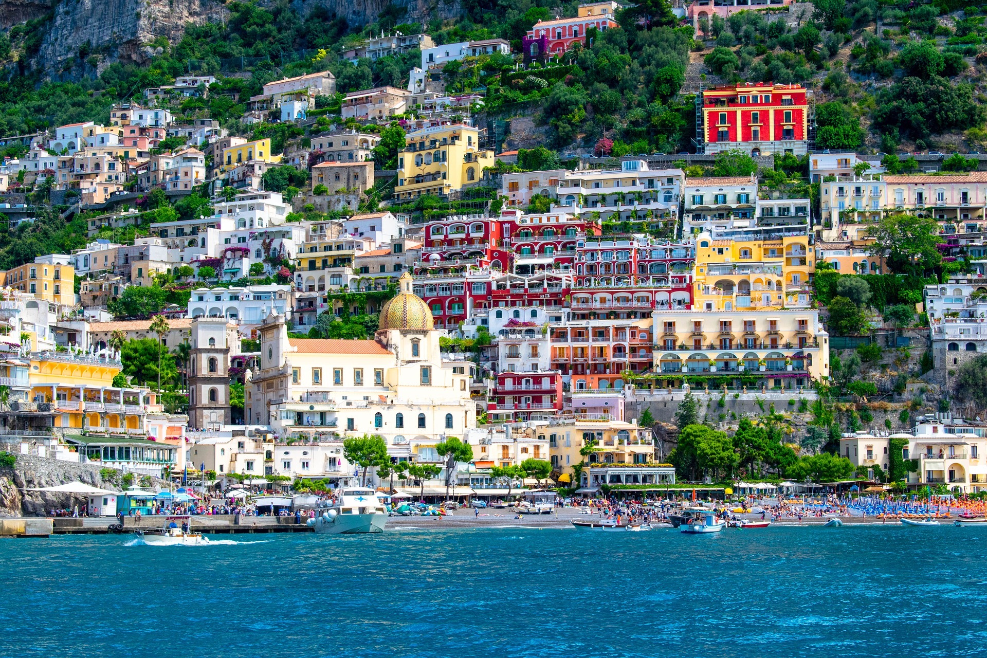 A view from the water up to some brightly coloured houses in Italy