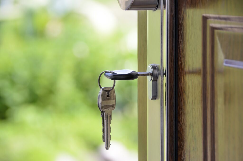 A door with a set of keys hanging in the lock