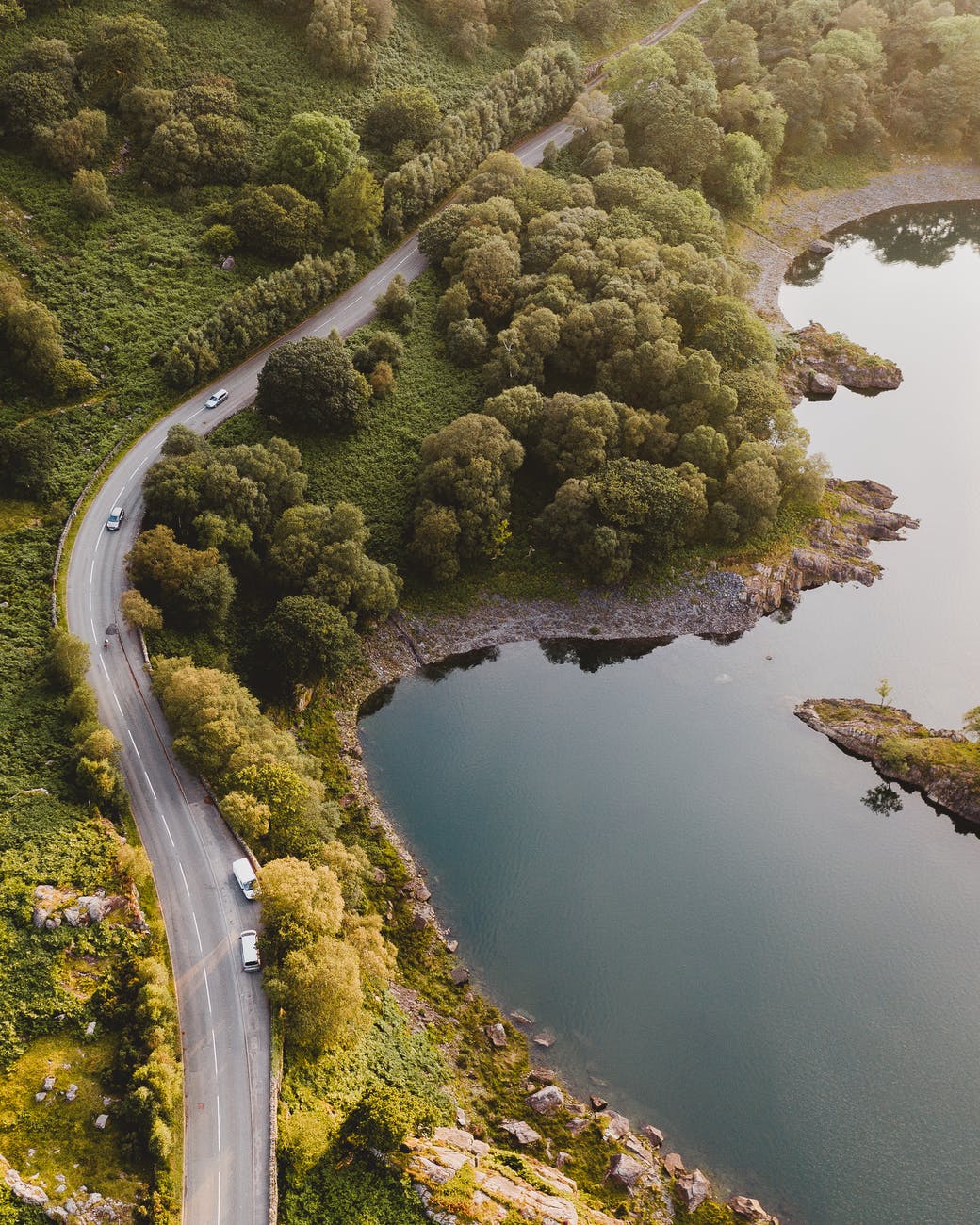 aerial photography of roadway and body of water