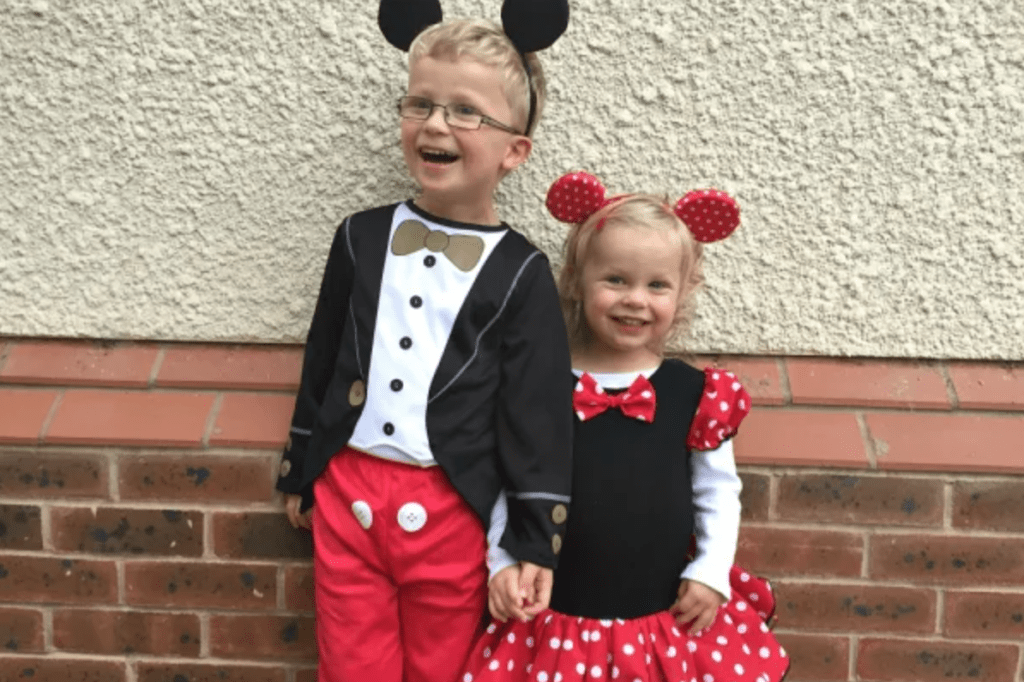 A little boy and girl dressed as Mickey and Minnie Mouse