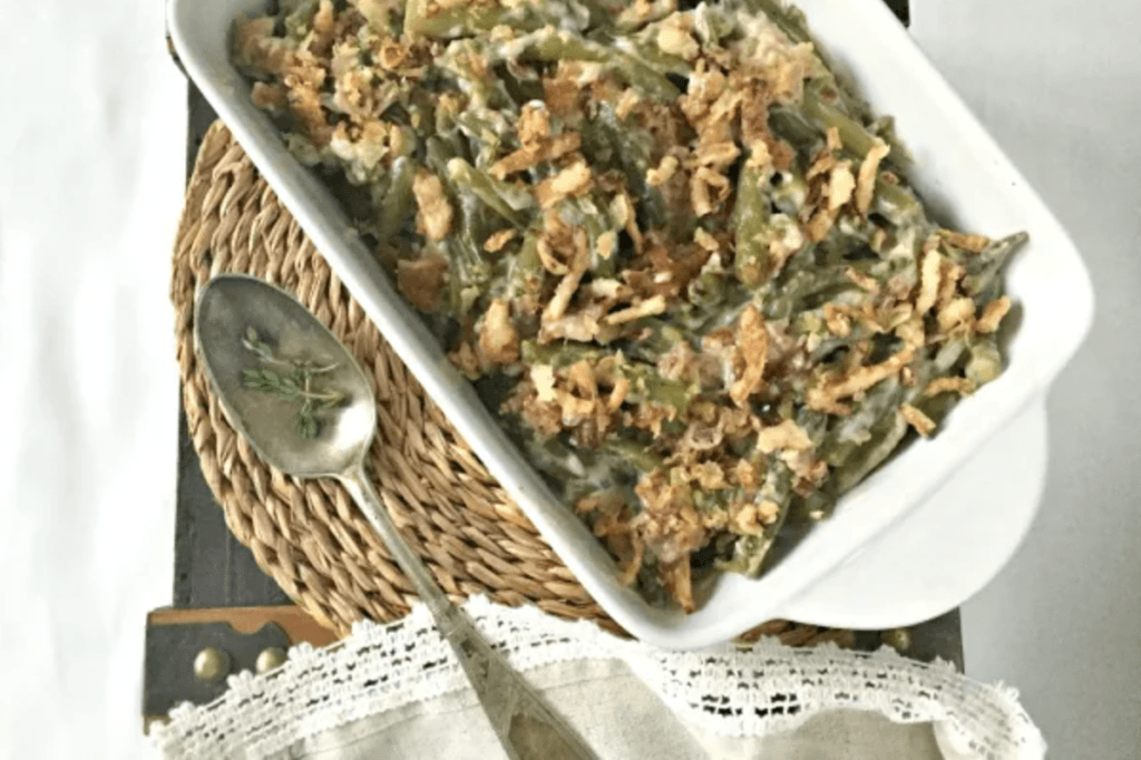 A dish of green bean casserole sat on a woven placemat