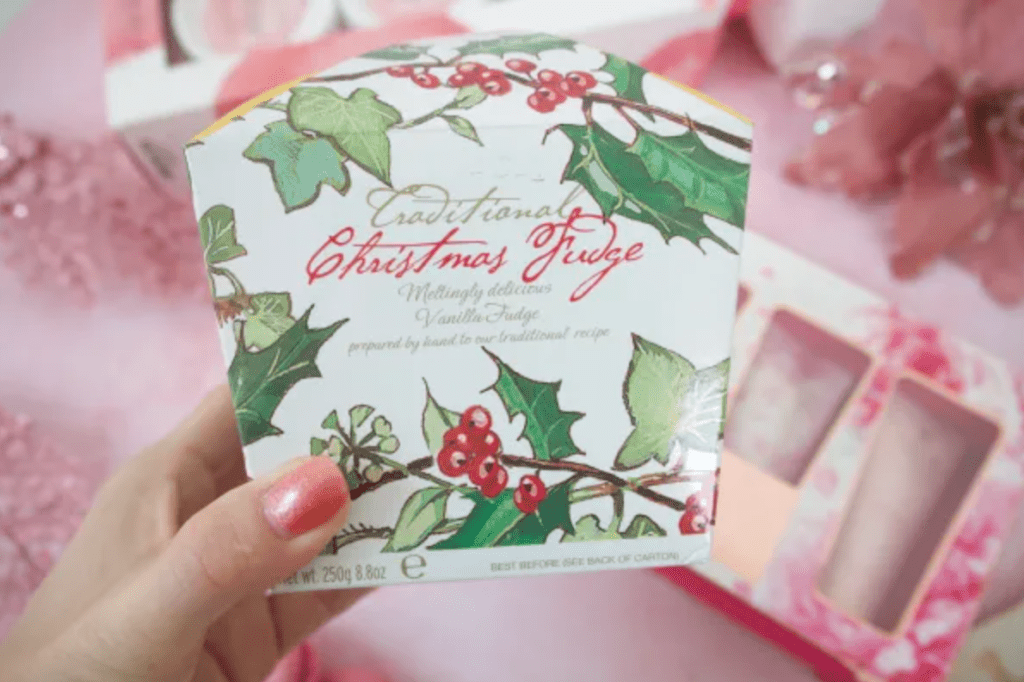 A box of Christmas fudge decorated with pictures of holly