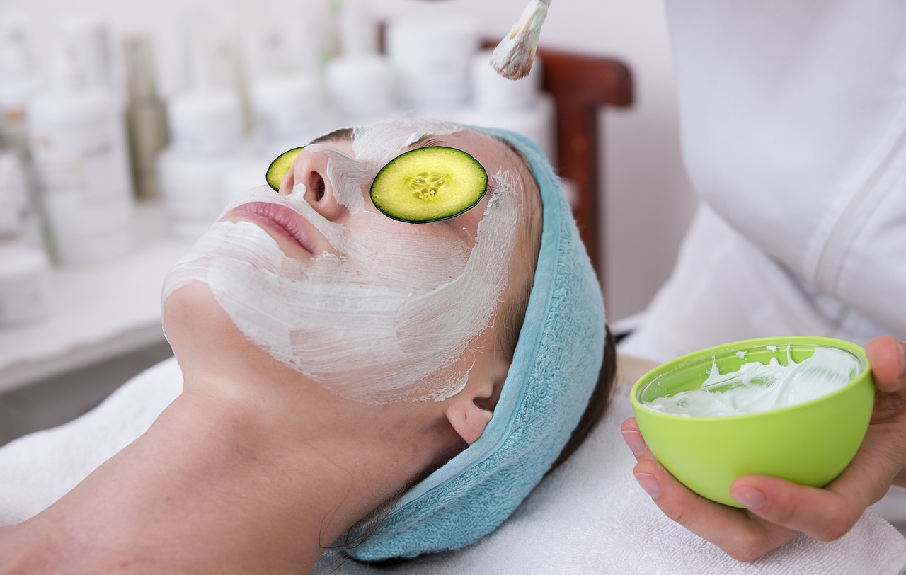 A woman receiving a skin-pampering cucumber face mask at a high-quality spa.