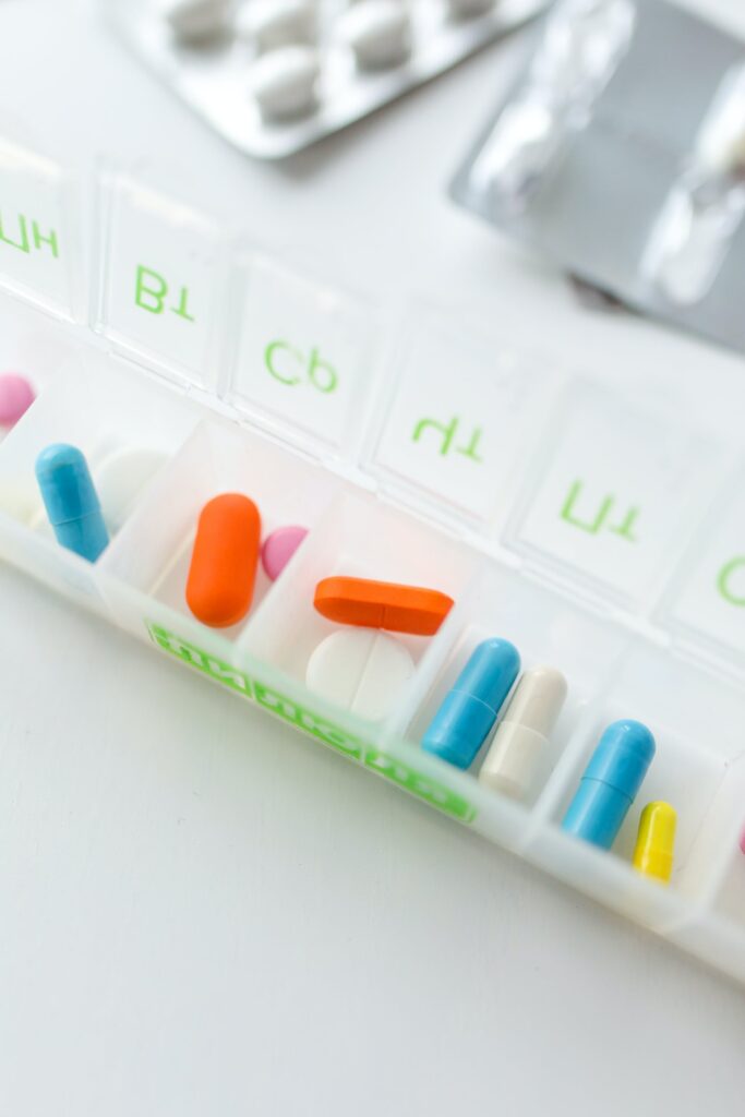 A really need box of pills and tablets on a white table.