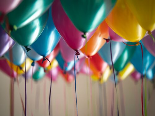 An artistic display of balloons floating in the air.