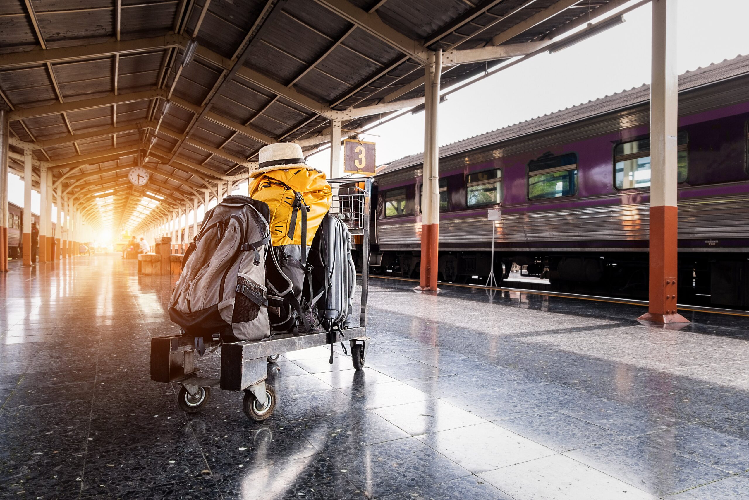A man with a backpack at a train station left luggage storage area.