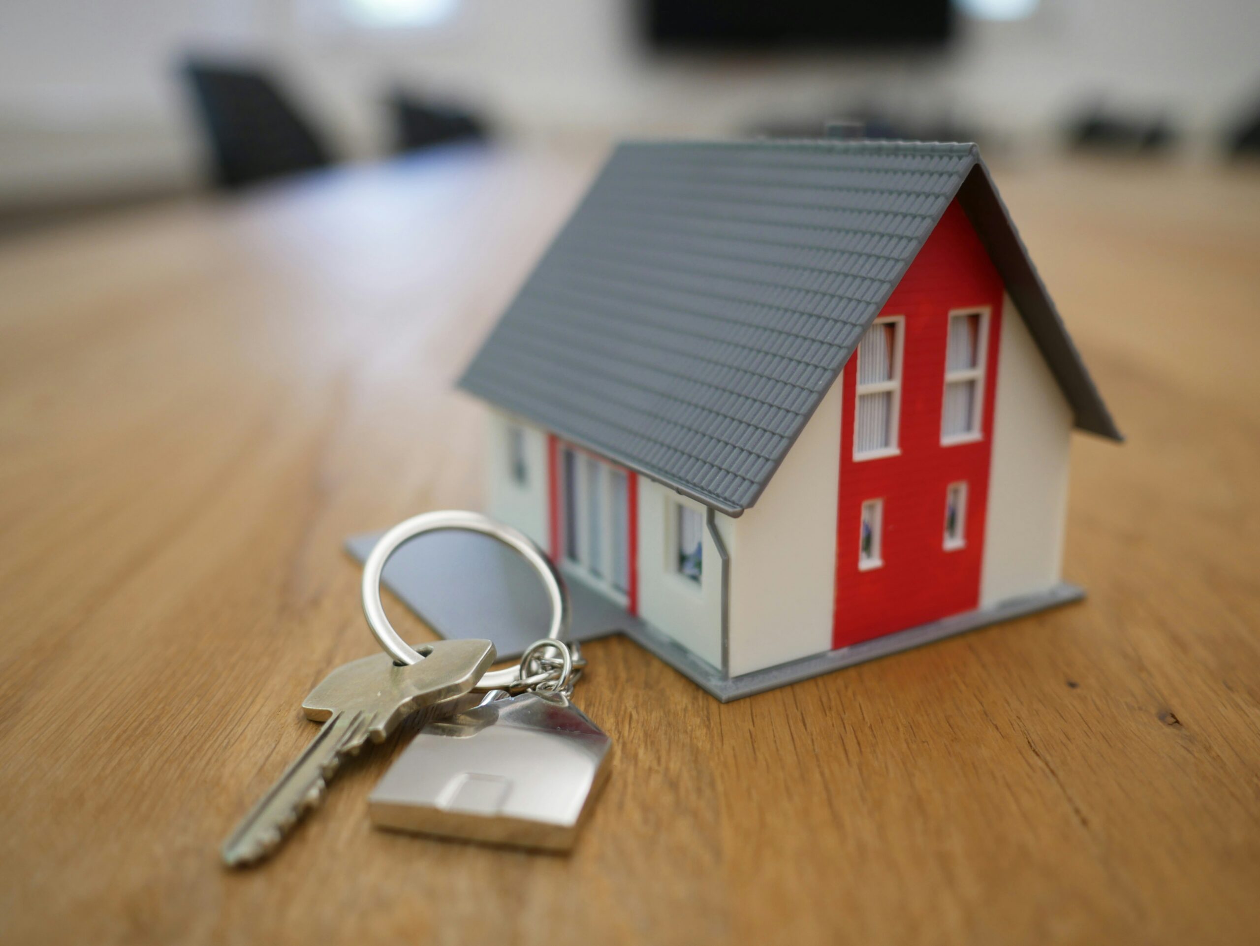 A model of a Arizona home with keys on a table.