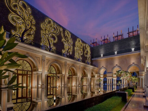 Elegant architectural corridor with ornate details and best places to visit in Chennai at dusk.